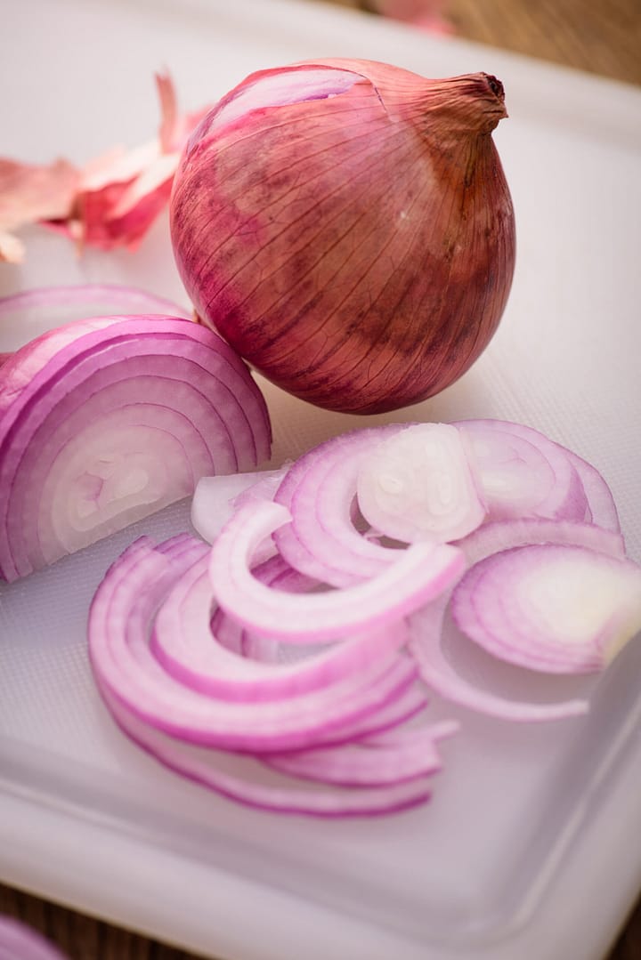 Red Onion Slices on white block